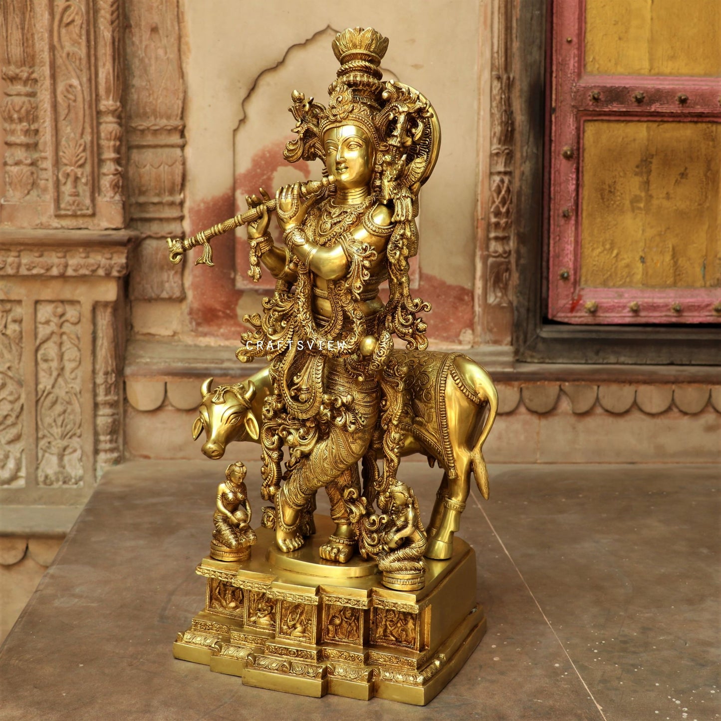 Lord Cow Krishna stands on an engraved base 28"