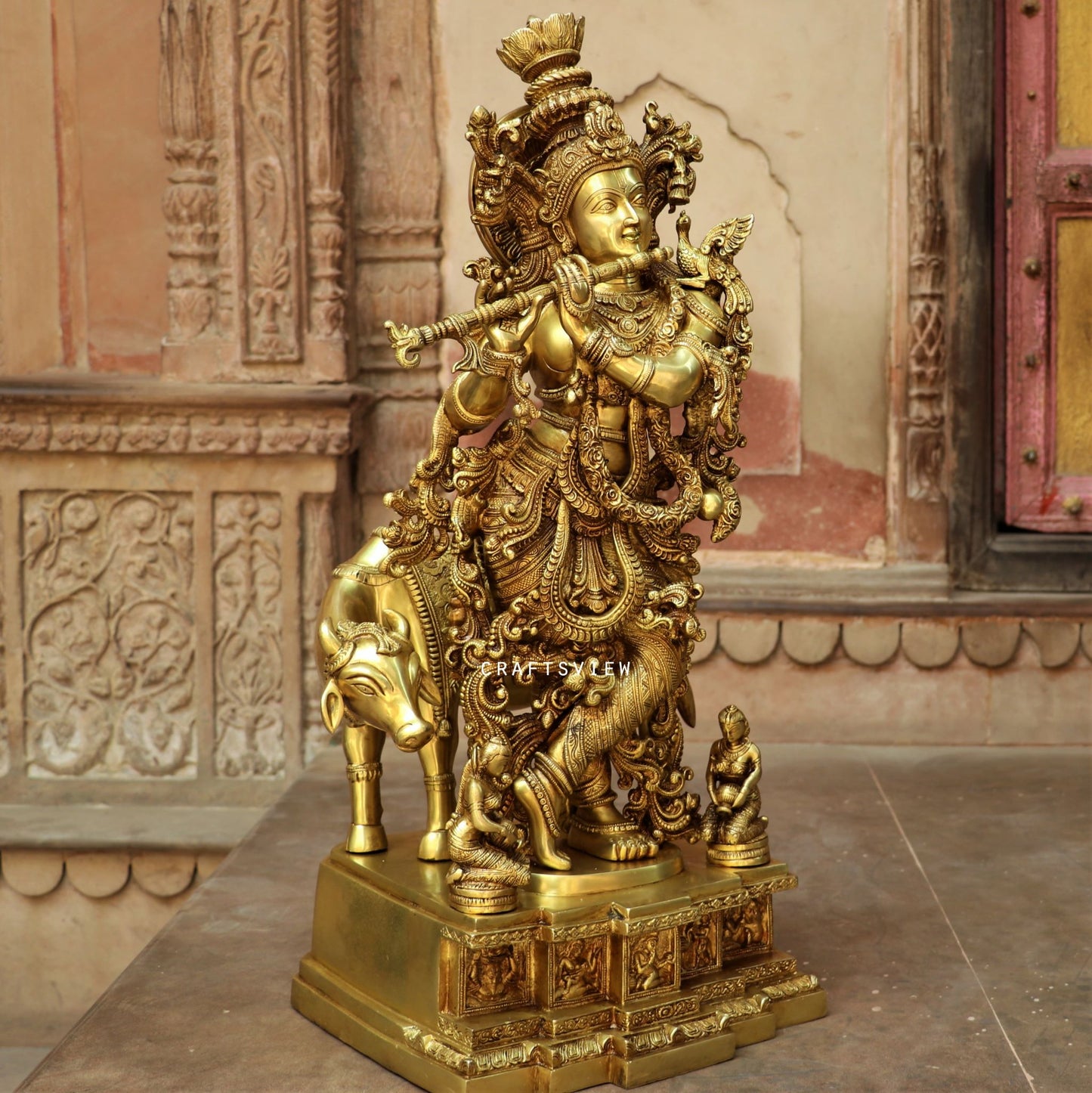 Lord Cow Krishna stands on an engraved base 28"