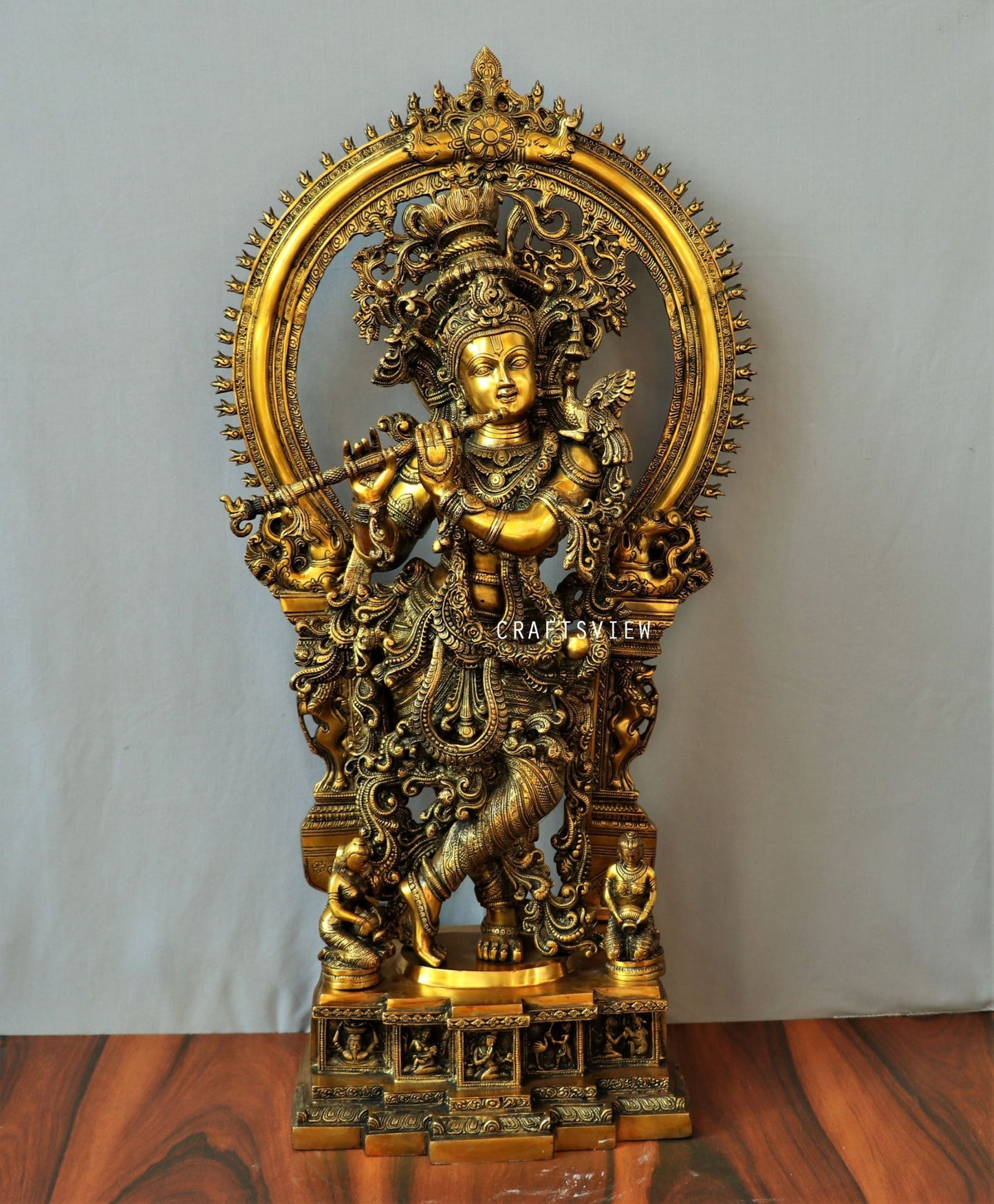 Lord Krishna stands on an engraved base with Frame 32"