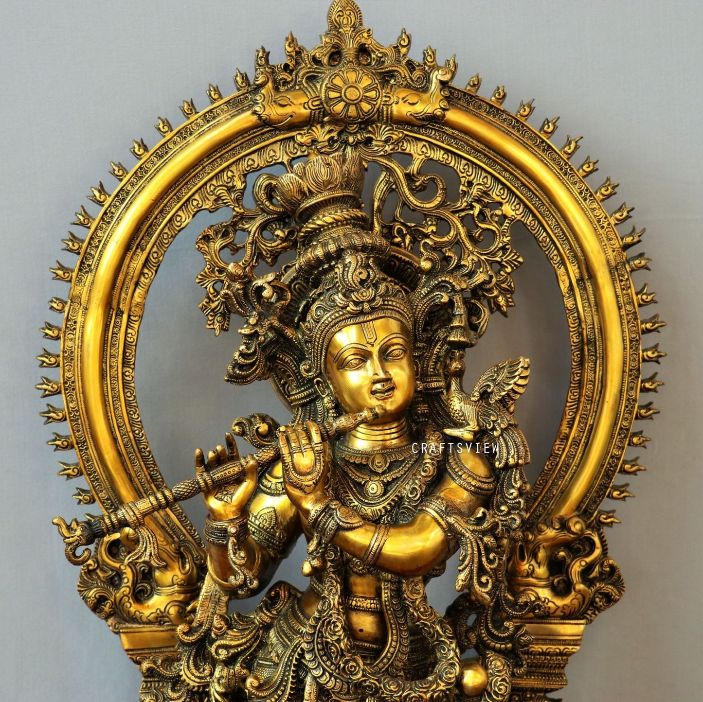 Lord Krishna stands on an engraved base with Frame 32"